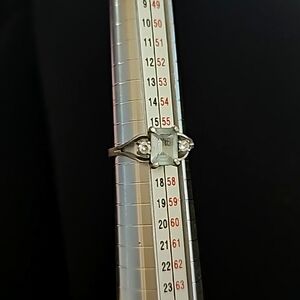 Sterling silver ring with blue stone and two small diamonds or cubic zirconia